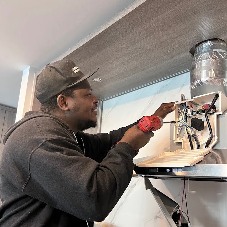 appliance repair technician working on garage system cloverdale appliance